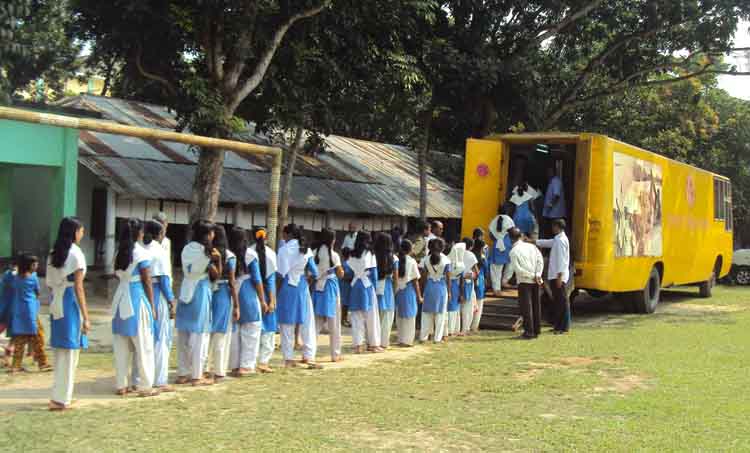 Students in Bangladesh line up to enter a  mobile branch of the Liberation War Museum