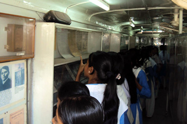 Young people read the written accounts of the liberation war of 1971 in in the mobile Liberation War Museum in Dhaka, Bangladesh